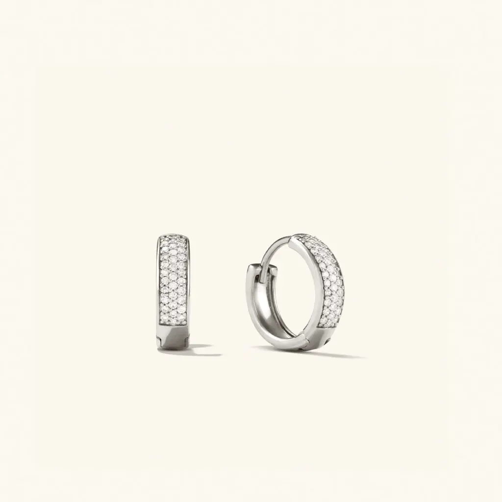 The Bold Pavé Diamond Huggie Hoops are stunning, high-quality earrings, with proceeds supporting programs that empower women and non-binary individuals. (Photo courtesy Mejuri)