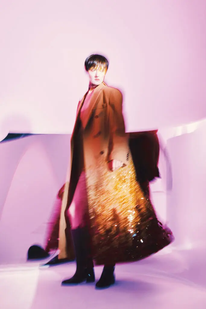 Gucci double-breasted wool coat $20,000, wool top $2,700, wool crepe short pant $1,700, silk ribbon $520, stud choker $2,950, and leather boot $3,500, at select Gucci boutiques, farfetch.com, net-a-porter.com.  (Photo by Fernando Rodriguez)