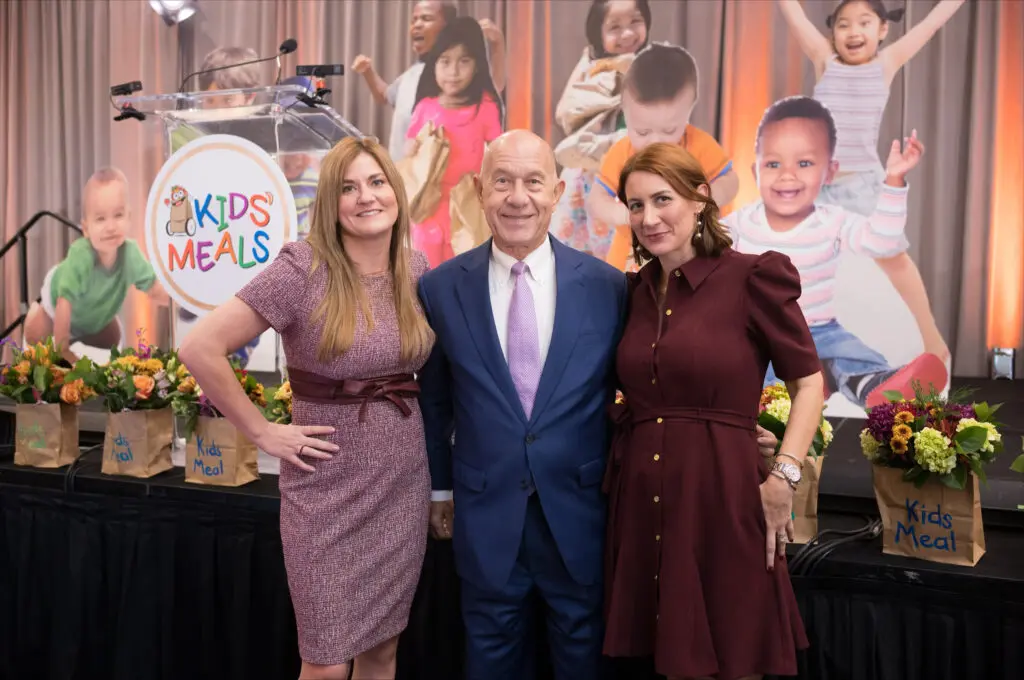 Kids Meals Harvest Luncheon chairs Sarah Whitmire and Whitney Whitmire flanking their father Mayor John Whitmire. (Photo by Daniel Ortiz)