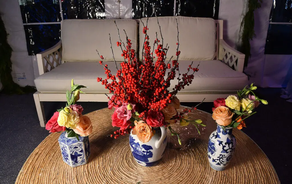 Pyracantha, roses and renunculus combine for a festive coffee table decor at the Kappa Kappa Gamma Charitable Foundation home tour preview party (Photo by Dave Rossman)