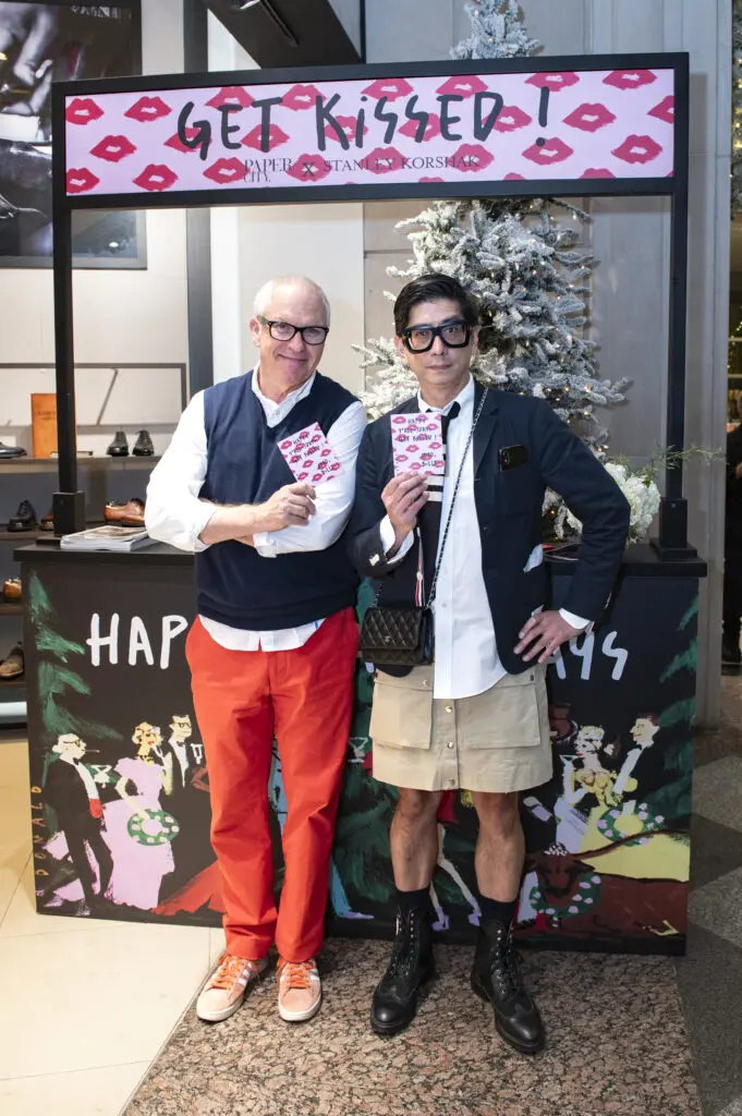 Local artist Donald Robertson created a "kissing" booth with cards for PaperCity's Billy Fong to hand out for the holidays. (Photo by Tamytha Cameron)