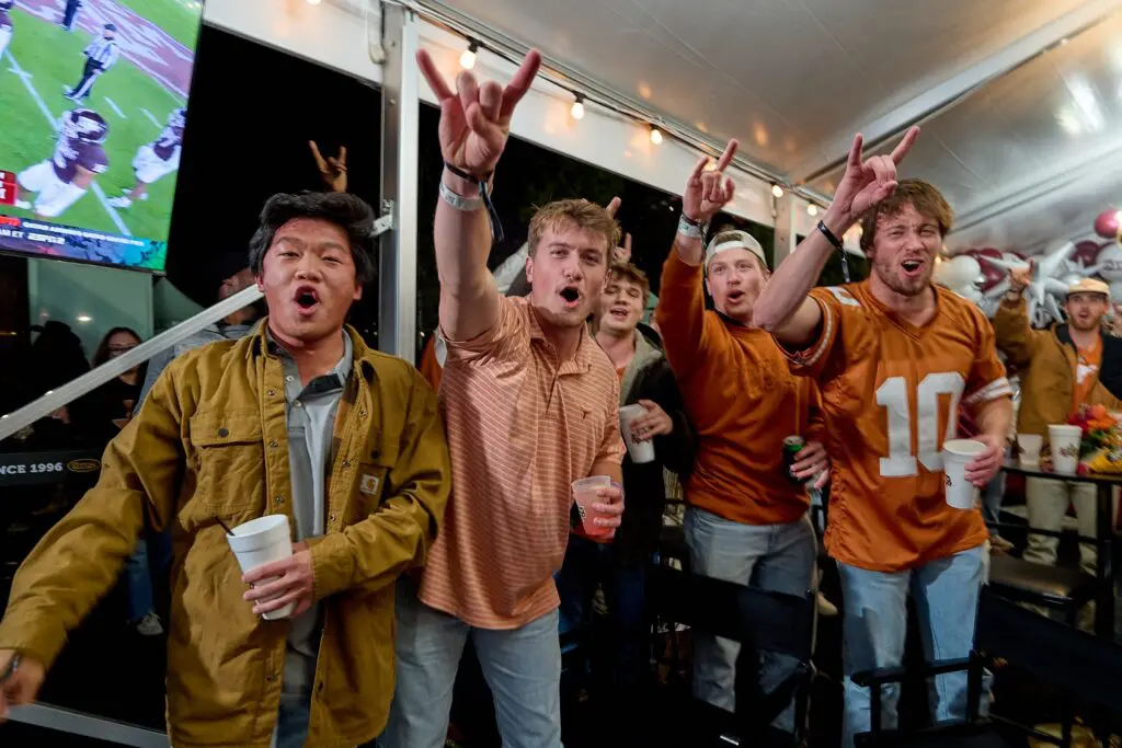 Longhorn fans celebrating the team's Lone Star Showdown victory at Cotton Holdings' tailgate party. (Photo courtesy of Cotton Holdings) 