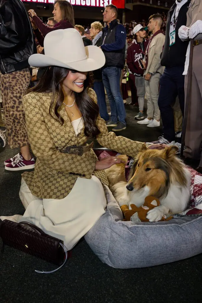 Zinat Ahmed with Texas A&M mascot Reveille on the sidelines at the Lone Star Showdown. (Photo courtesy of Cotton Holdings) 