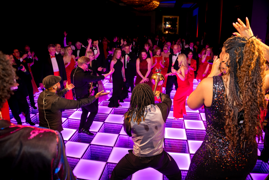 The crowd dances to the sounds of Midtown 10 on the dance floor at the American Heart Association Heart Ball. (Photo by Christina Griffin)