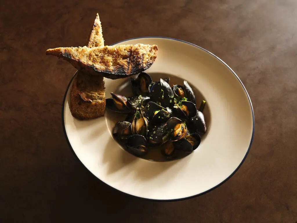 Caswell's Shiner Bock steamed mussels with rajas and garlic bread shine at Latuli. (Photo by Frank Frances)