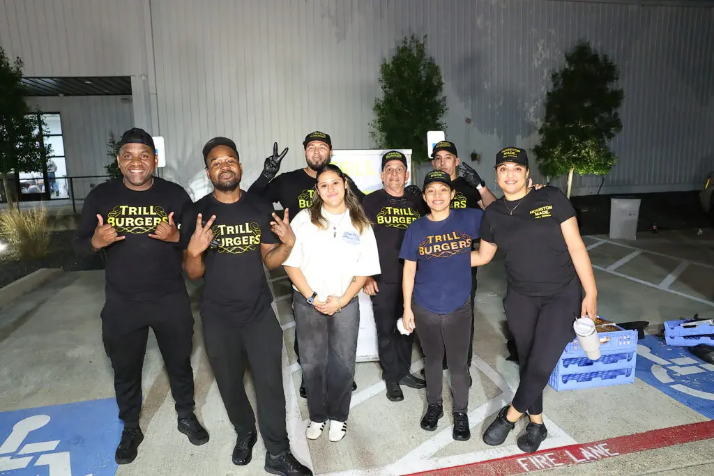 The Trill Burger Team delivering end of night burgers for the departing crowd at the Sky High for Kids 'Better in Boots' gala (Photo by Quy Tran Photography)
