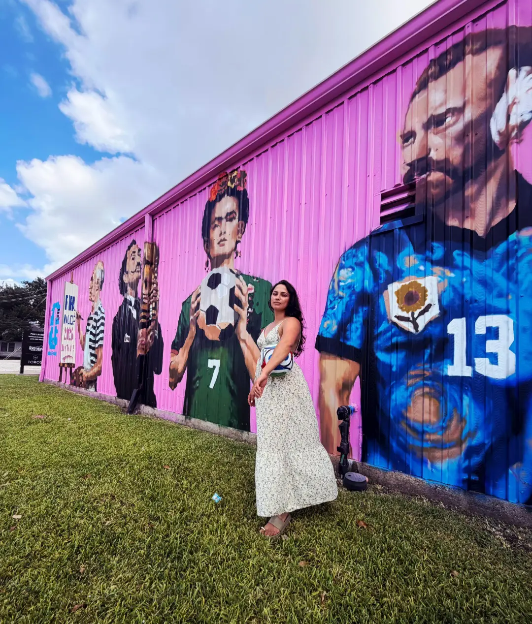 Artist and muralist Jatziri Barron stands near her mural, “The Art of the Beautiful Game,” 2026, which features artists Pablo Picasso, Salvador Dalí, Frida Kahlo and Vincent Van Gogh. (Courtesy Jatziri Barron)