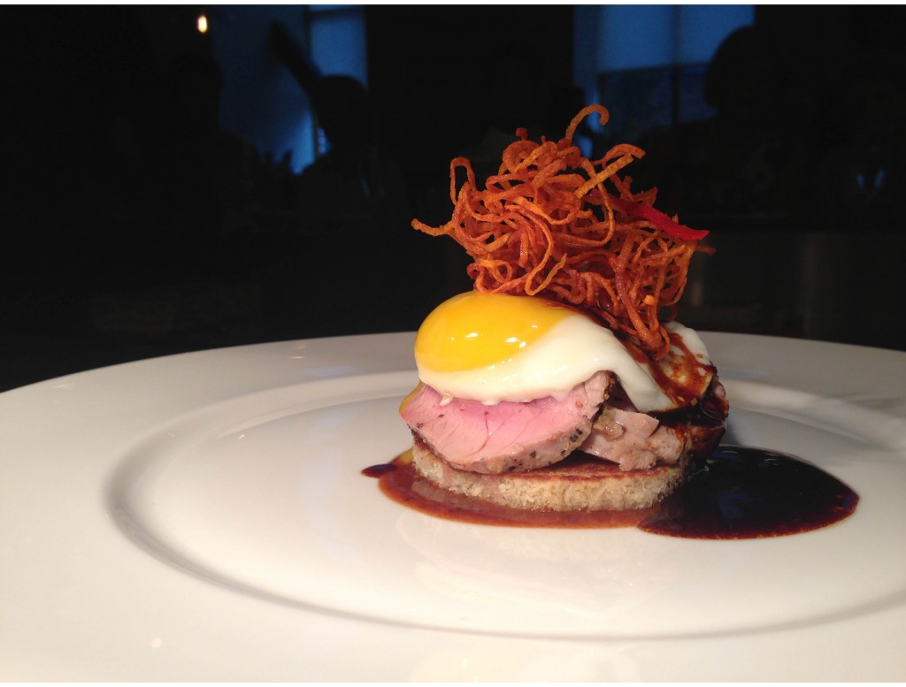 Mustard seed crusted pork loin with a sunny side up egg, fried carrot and brioche pork reduction