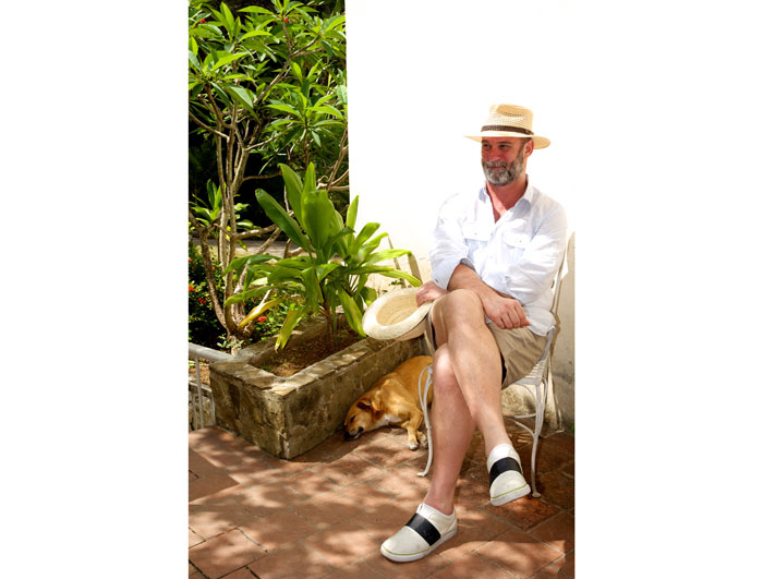 Tearlach relaxes outside the house.