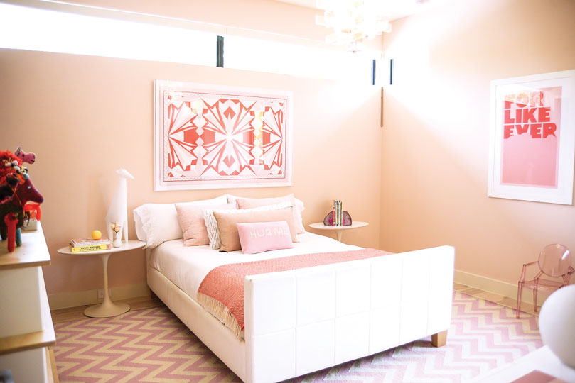 In the bedroom of Clair’s daughter, Slayton, vintage Emilio Pucci scarf is framed above the bed. Pink-and-red coordinating print by Super Rural, For Like Ever. Vintage Lucite chandelier from Scout Design Studio.