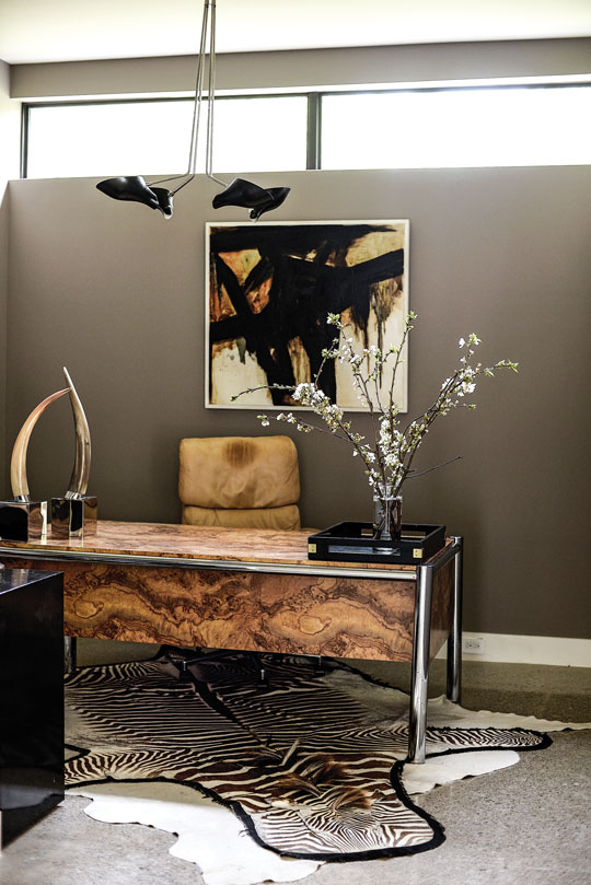David's (Clair's husband) office features a vintage ’70s desk fabricated of burled wood and chrome. Vintage chandelier from David Weeks.