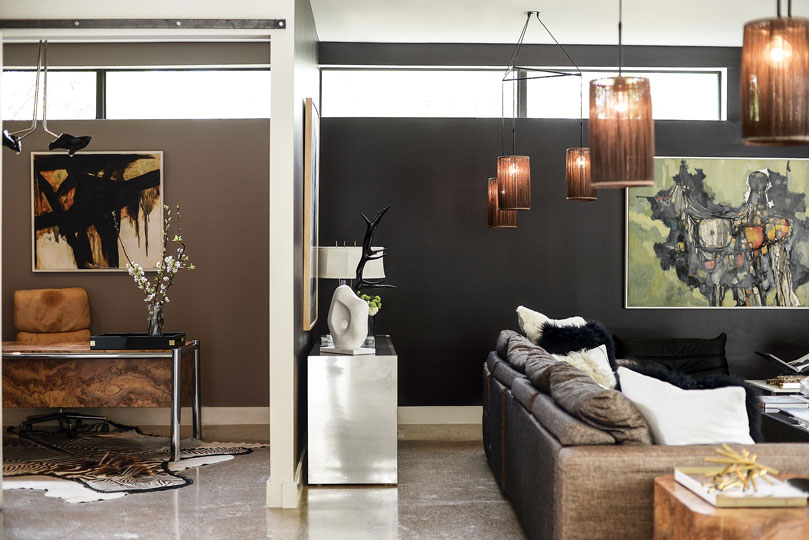 Side by side: Adjacent to David’s office is a mirrored-and-brass Ello credenza from Scout Design Studio, topped by a white Kelly Wearstler sculpture from Forty Five Ten. Suspended wire-mesh chandeliers from Revolve Modern illuminate a metallic-fabric Mezzo sofa from Bo Concepts. Artwork Paul Rotterdam.