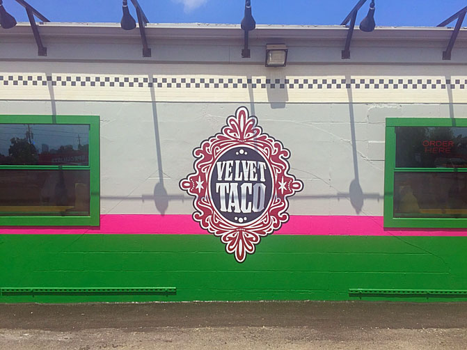 The Velvet Taco logo is stamped on the building's exterior. 