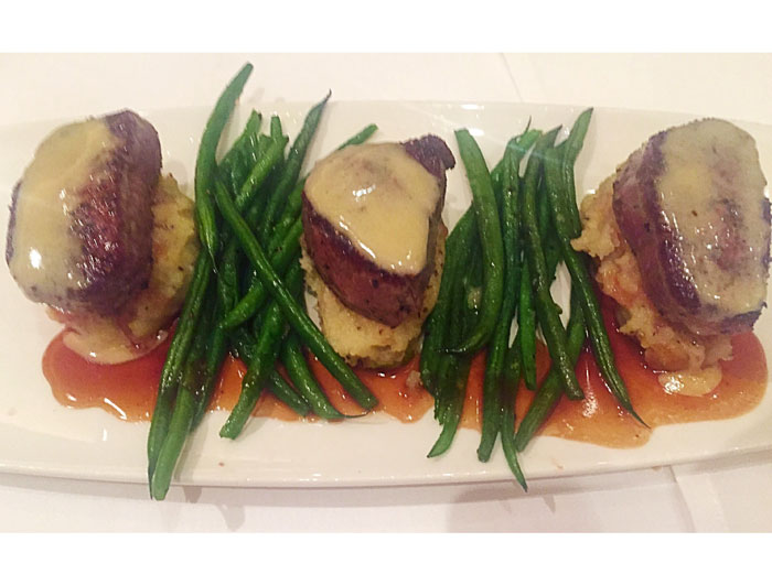 The 3-ounce filet medallions are served with a bordelaise sauce, chateau potatoes and thin green beans. 