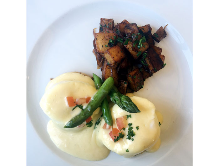 Table's benedicts can be ordered traditional or with a crab cake and are served with asparagus and breakfast potatoes. 