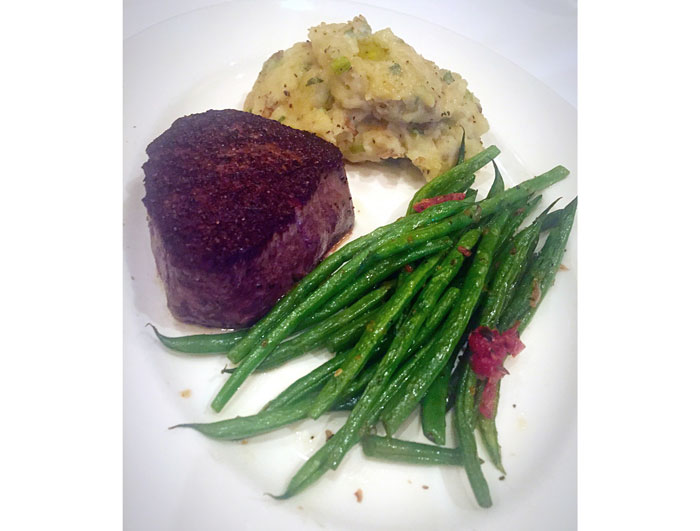 The 8-ounce filet at Del Frisco's is served with chateau potatoes and thin green beans. It is one of four second-course options.