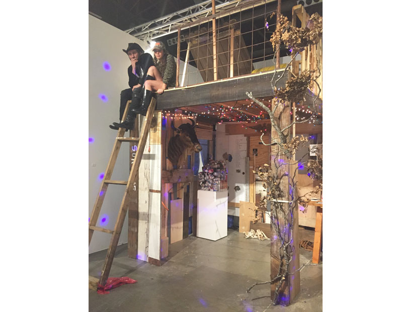 Paul Middendorf and Lina Dib cavort at the Art League's booth, which channeled a deer blind.