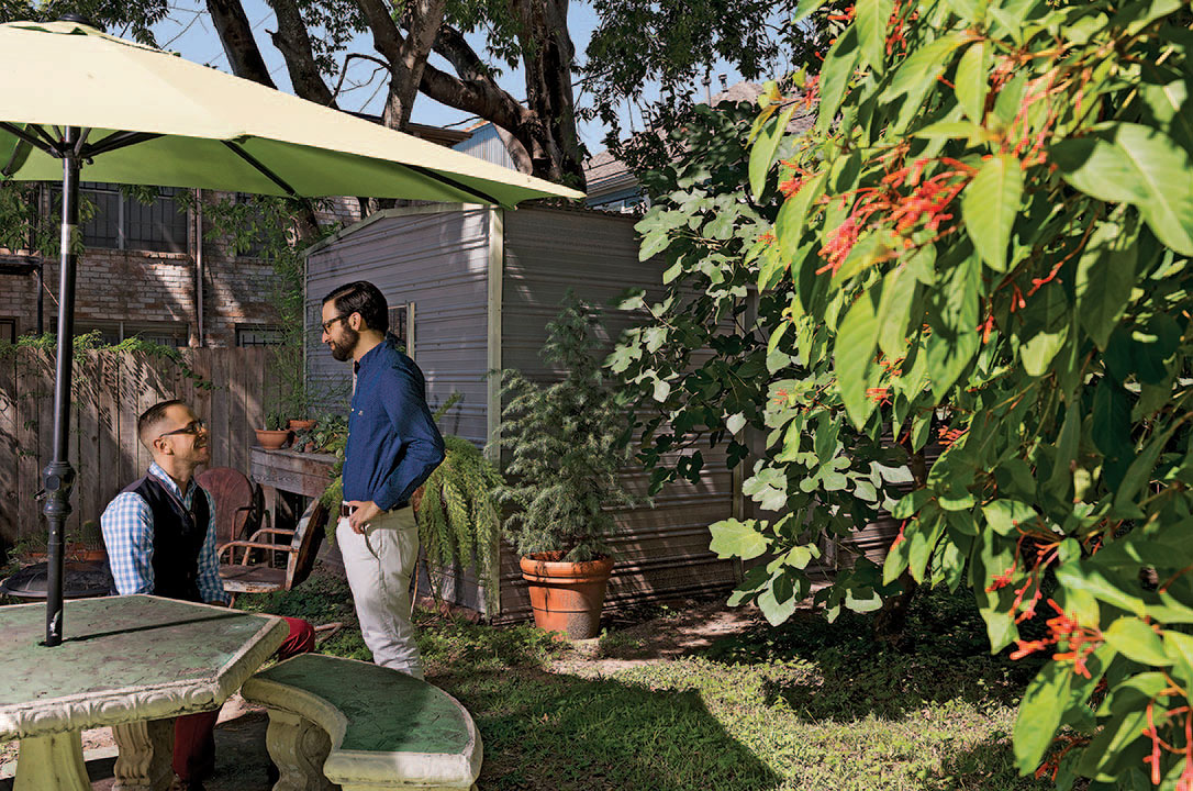 Sensabaugh and Scott sharing a moment in their backyard, which includes seasonal herb and vegetable gardens and a large fig tree.