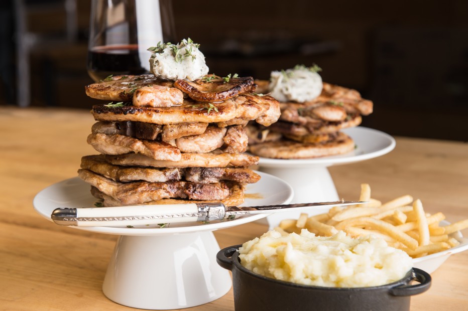 Cake stand pork chops at Hunky Dory. Crispy pork chops served in multiples of four are stacked with mashed potatoes and French fries. (Photo courtesy Treadsack Group)