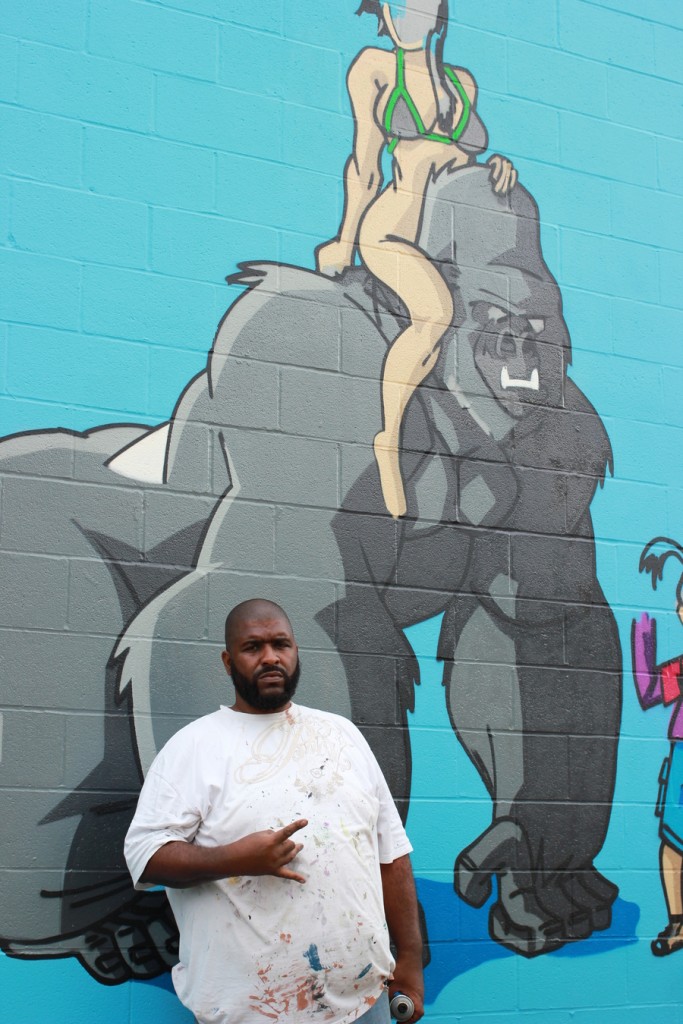 Deck WGF poses with his mural. (300 N. York St.)