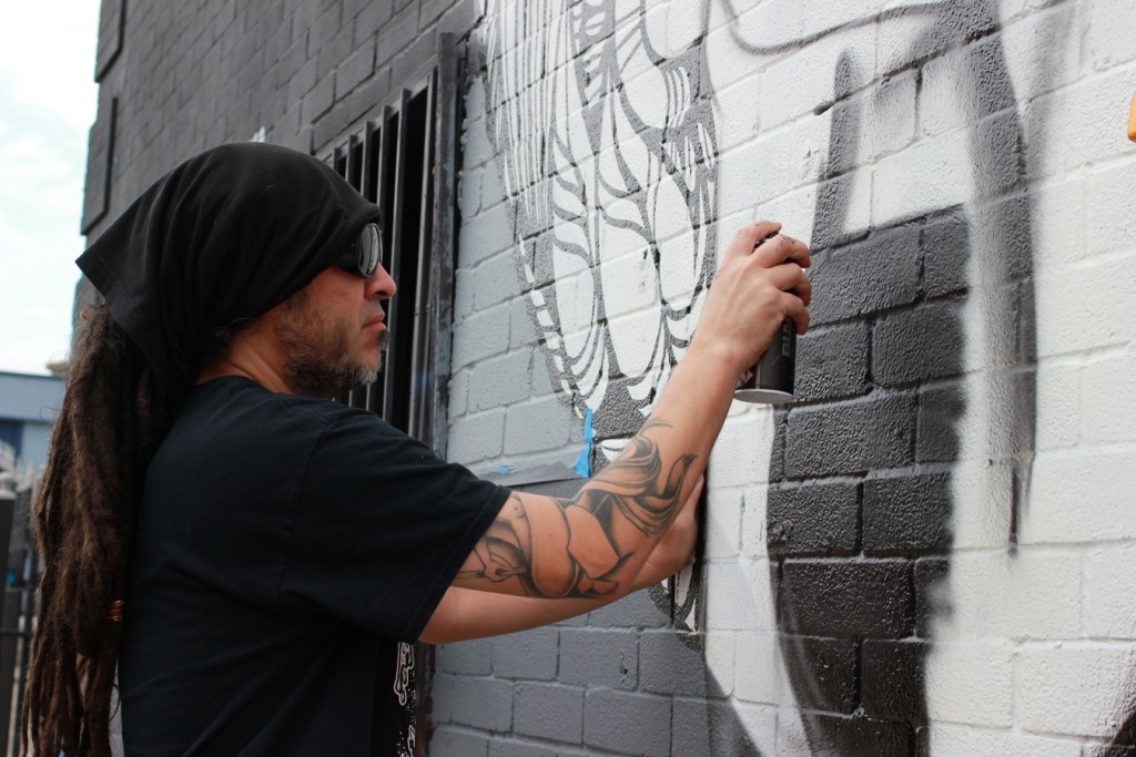 Nick Soupe working on the details of the mural. (4739 Canal)