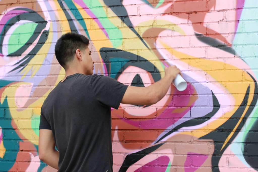 Leche at work on his mural. (6697 Capitol) 