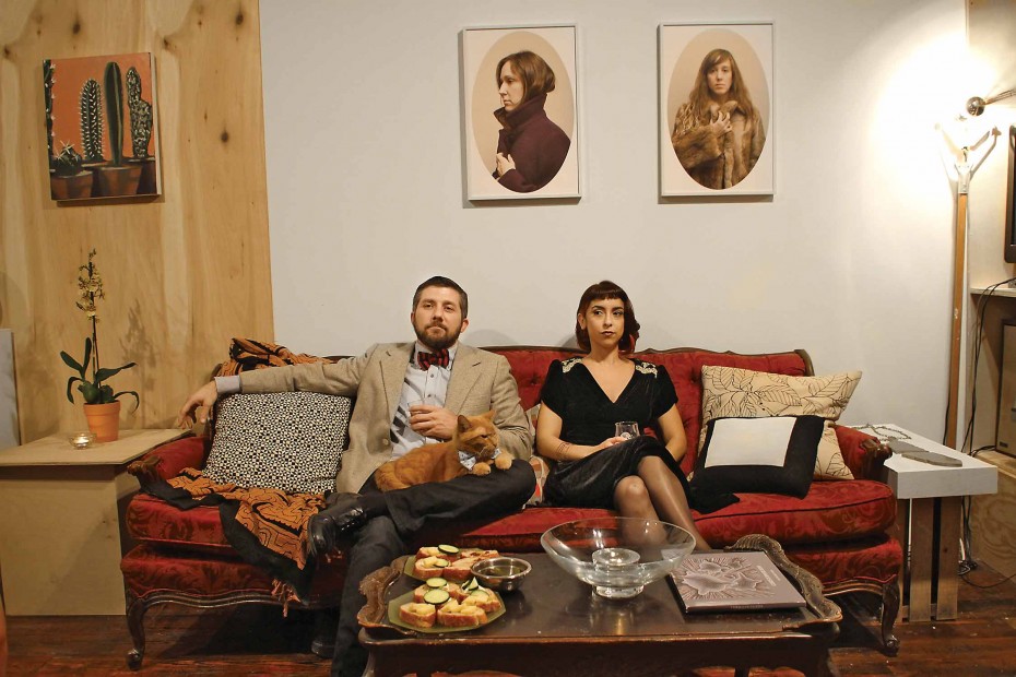 Paul Middendorf and Olivia
Abbott, with Ike the cat, sit in Middendorf’s abode
adjoining GalleryHomeland.