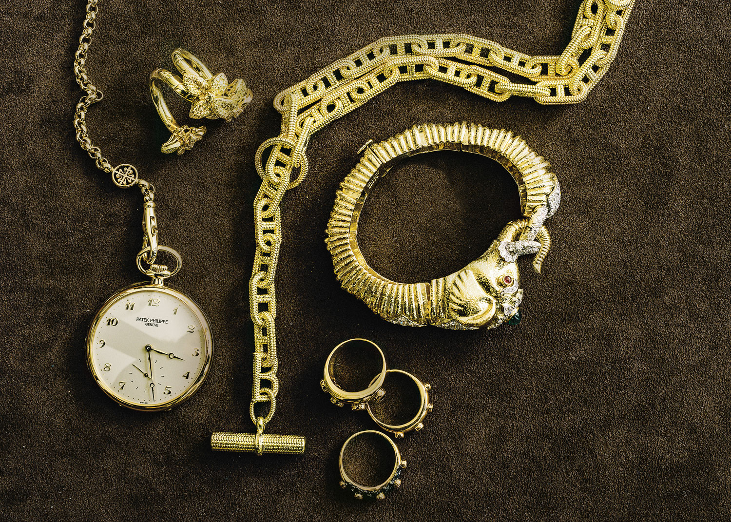 Patek Philippe Lepine pocket watch, De Boulle Collection three-flower foldable ring, De Boulle Collection large textured rope toggle necklace, David Webb gold and platinum elephant bracelet with emerald, rubies and diamonds, De Boulle Collection triple-stack rings with bezel-set round brilliant black diamonds