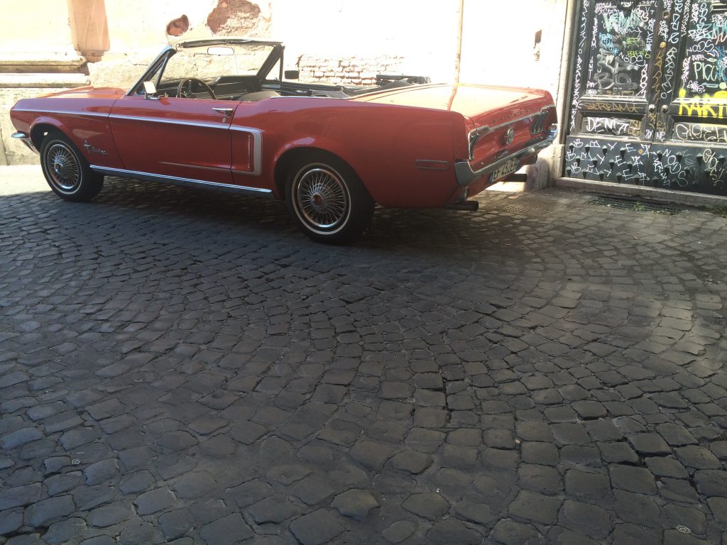 A vintage Ford Mustang in the Trastevere neighborhood is ready for a joy ride. 