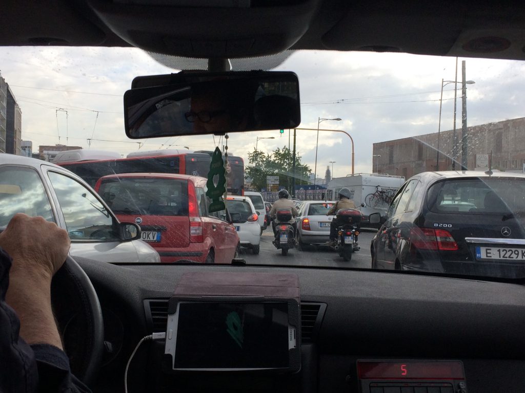 View of crowded Italian traffic from inside our taxi.