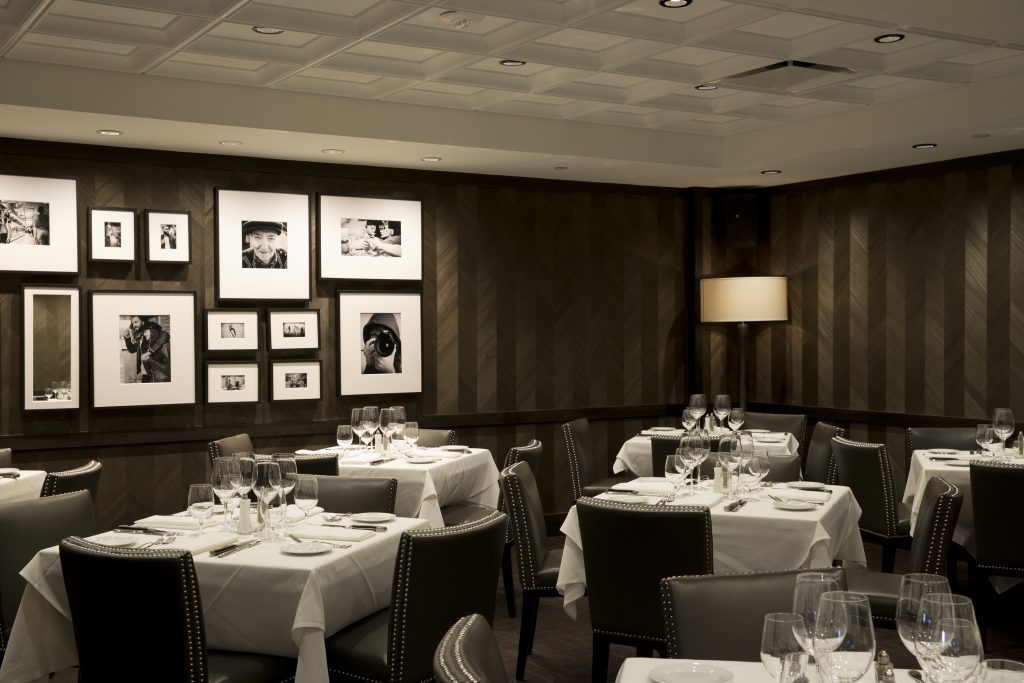 Monochrome photographs line the walls in the upstairs dining room. 