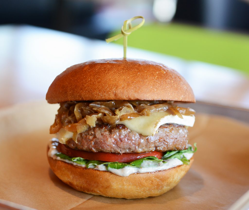 The Primetime burger is made with grass fed beef, brie cheese, arugula, caramelized onions, truffle aioli and steak sauce.  