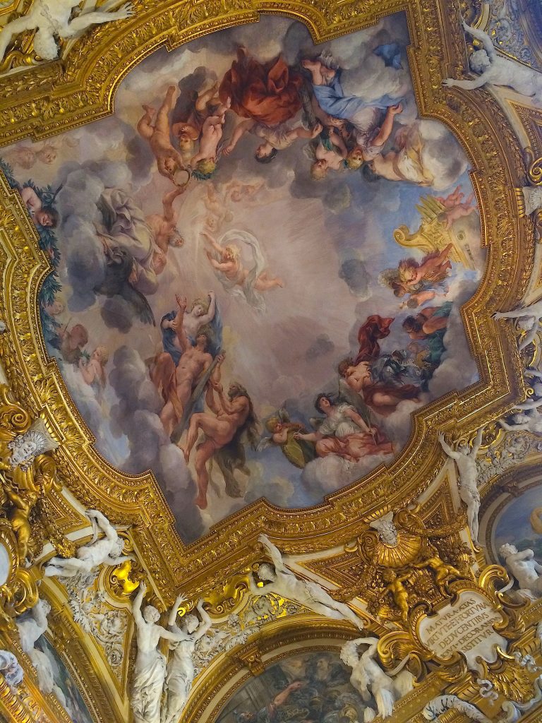 Baroque ceiling fresco with gilded and white stuccoes.