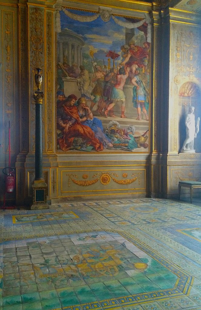 Majolica tiled floor in the Salla della Stufa. Wishing for less glare from sun streaming in the windows so one could better see the elaborate floor patterning.