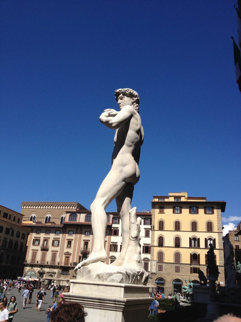 Replica of Michaelangelo's larger-than-life David outside the entrance to Palazzo Vecchio.