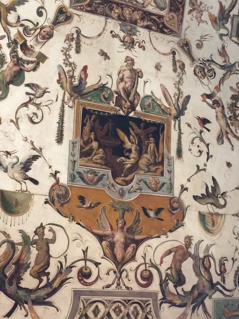 Painted ceiling detail populated with birds, insects and imagined beings.