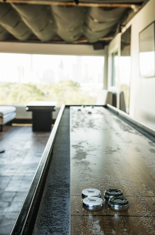 A shuffle board table can be used for games or dinner. 