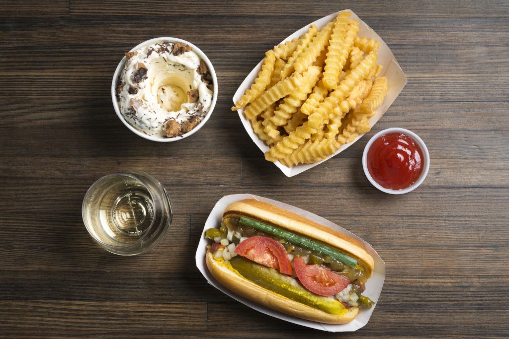 Another menu staple, Shake Shack's Shack-cago dog with the obligatory glass of wine. 