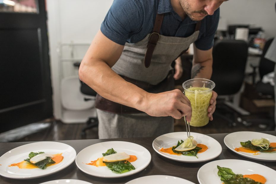 chef Ryan Lachaine plates at Aces of Tastes' Gulf Coast inspired wine dinner. Lachaine makes his executive chef debut with Riel this fall. (Photo by Jay Tovar)