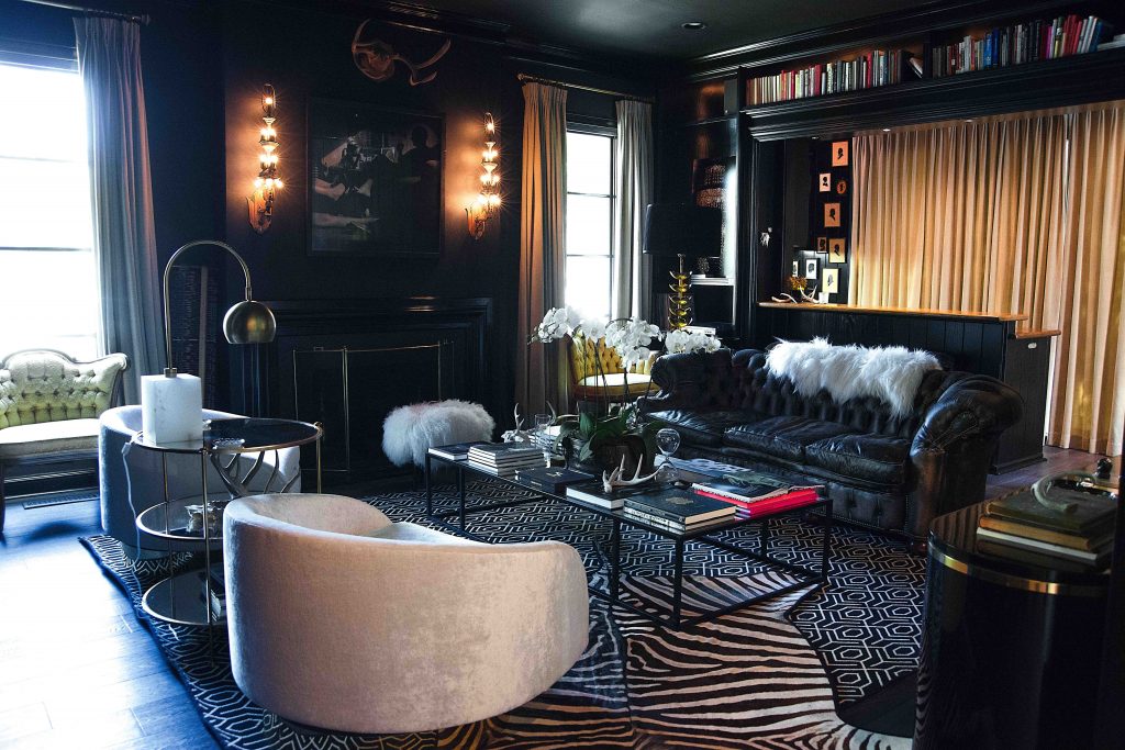 In the library, vintage swivel chairs from Antiques Moderne in Designer's Guild velvet; round side table by Worlds Away; Wisteria coffee table; Arteriors lamp; French theater sconces from Found Antiques; Chesterfield leather sofa from Restoration Hardware