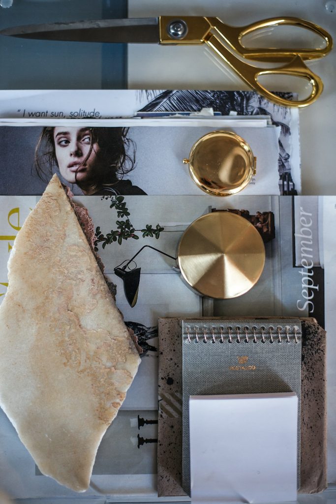 Inspiration board with a stone unearthed during the Adolphus renovation
