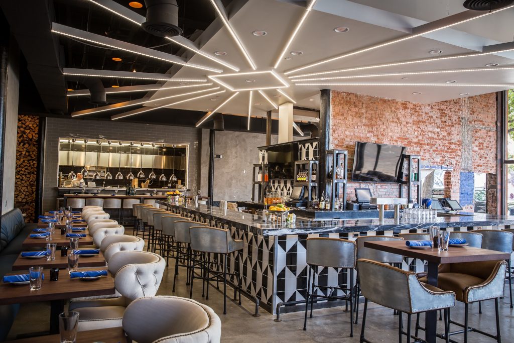 The restaurant features exposed brick walls and polished concrete floors.