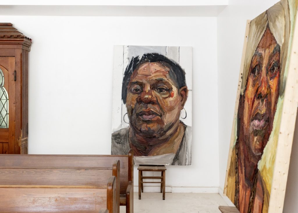 In a chapel-like space within the house, Huckaby's portraits of his aunts. From left, "Jeanette, Net, Nanna"; and "Alice, Prophetess Jones," both painted 2013.