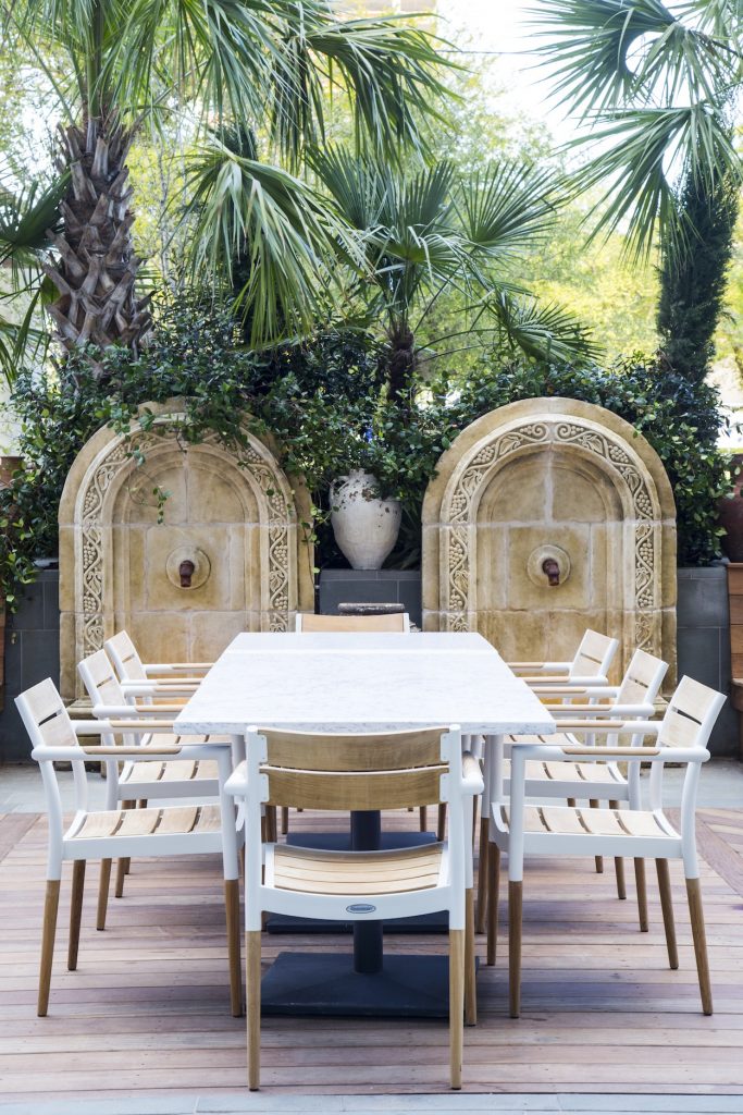 Engulfed in palm trees, the patio is an urban oasis.