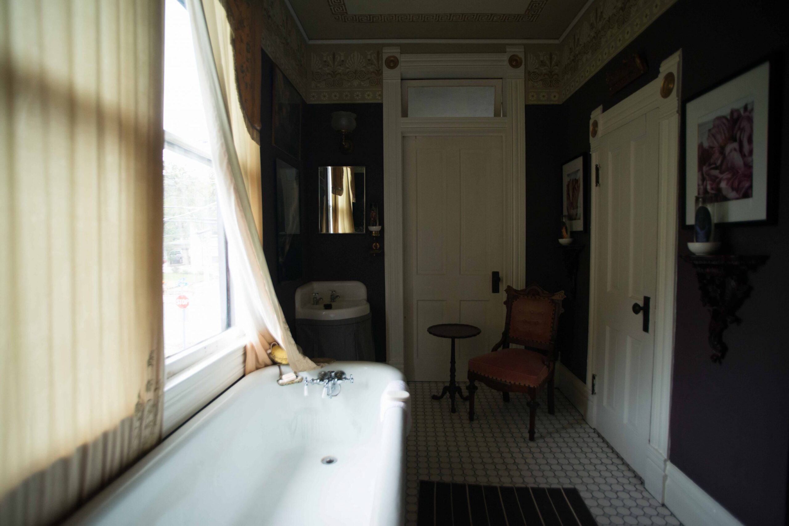 Original tub and sink, circa 1910. Antique Eastlake chair.