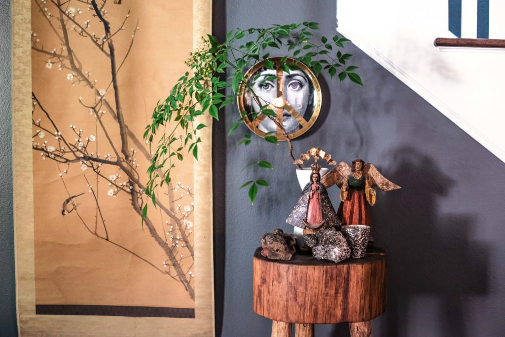 In the dining room, Japanese scroll from the house where Achor Hayes grew up. Chopping block was a 1980s flea-market find. Carved wooden santos collection includes pieces from her parents and a gold-crowned virgin, a gift from Todd Oldham and Tony Longoria.