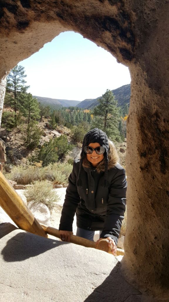 The author climbs the ladder to the entrance of an old Pueblo cave dwelling.