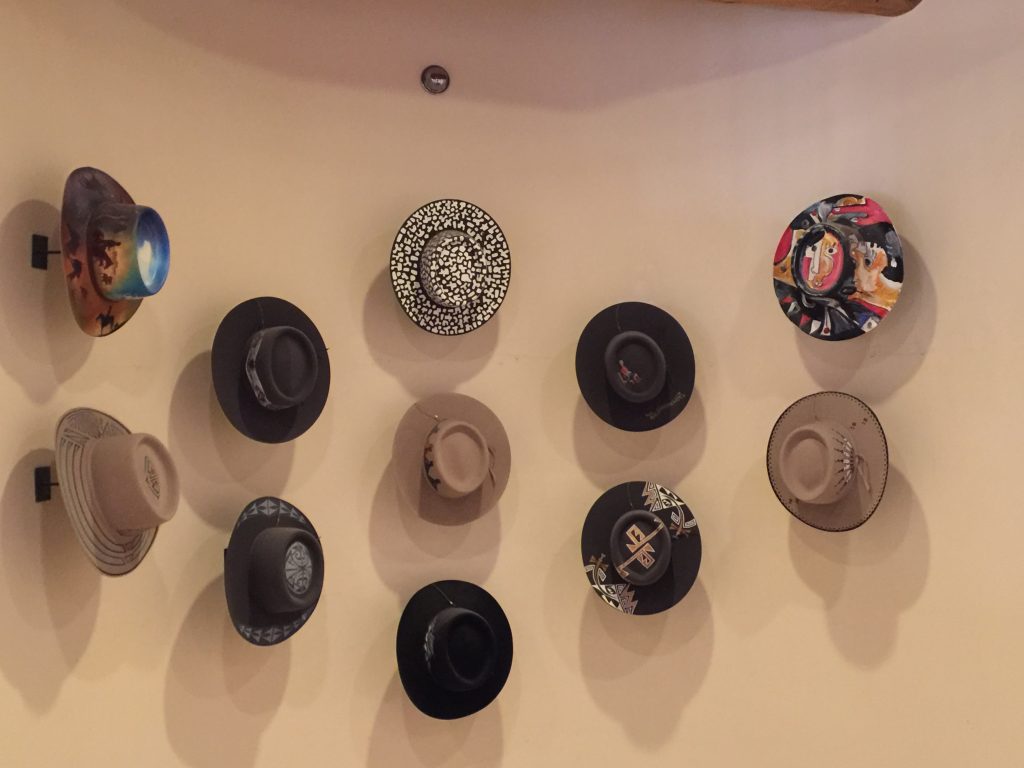 The wall of hats at La Fonda Hotel is a distinctive touch.