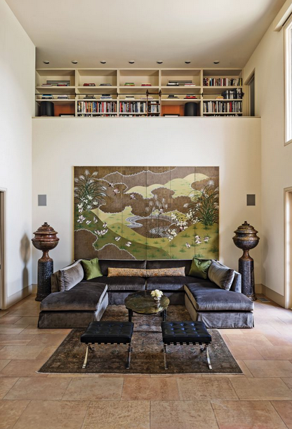 (4) A loft above the living area serves as a library. Japanese painted screen, circa 1960, from Coconut Company, NY. Custom sofa in Donghia wool/silk velvet, with pillows in Oscar de la Renta green silk, all from Dennis Brackeen Design Group. Antique tapestry pillow from Antique Textiles Collections, NY. Philip and Kelvin LaVerne coffee table, circa 1960. Buccellati vase. Miles van der Rohe for Knoll stools. Antique Persian rug from Jamal's Rug Collection, Los Angeles.