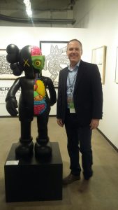 Heritage Auctions’ Ed Beardsley converses with a KAWS sculpture set for the auction house’s May 22 New York Modern and Contemporary Sale.